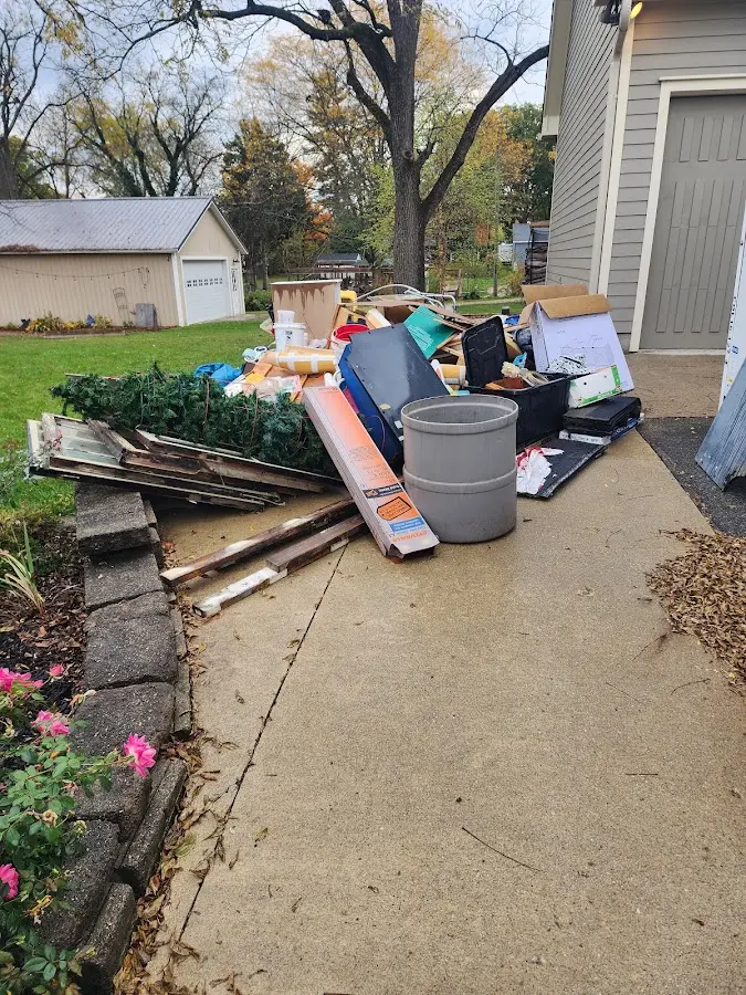 Dumpster being loaded with debris for Estate Cleanout Dumpster Rental in Dulles Town Center